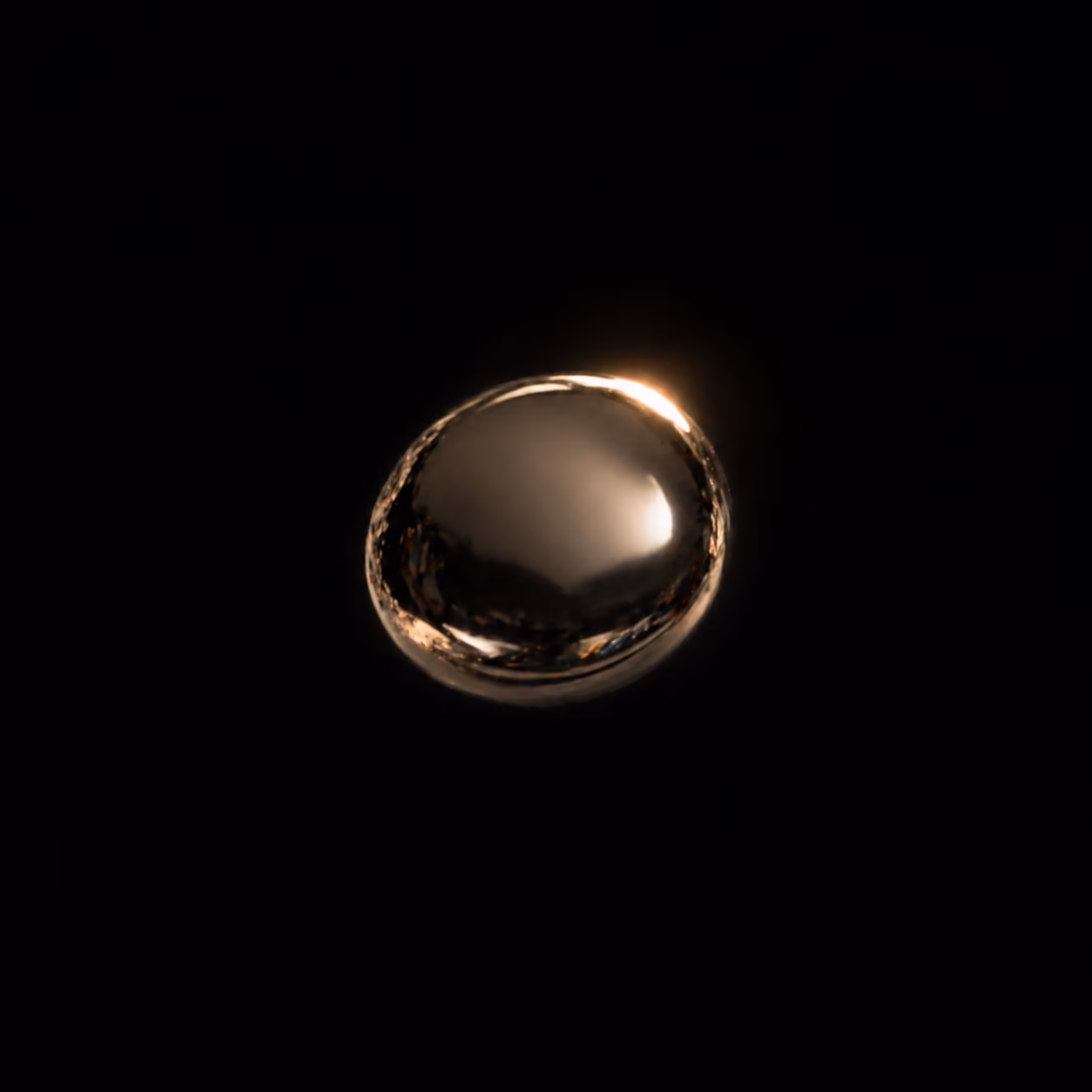 A single golden droplet against pure black — quiet intelligence